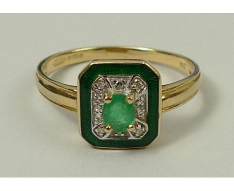 A 14ct gold and emerald ring, the central oval emerald set in a canted rectangular surround set with chip diamonds, within a 