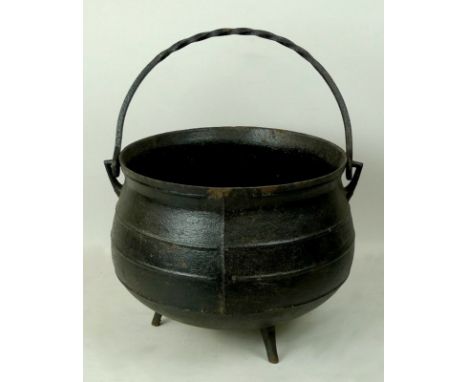 A late 19th century cast iron three ring cauldron, 34 by 25cm.