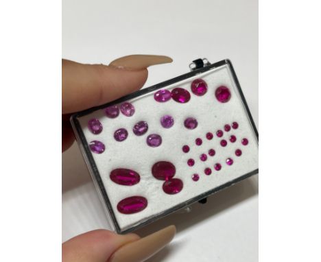 14.32cts of pink and light red stones all of different shades and cuts 