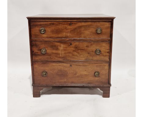 A Georgian mahogany chest of drawers comprising three long drawers each with two brass ring-pull handles raised on ogee brack