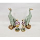 Pair of Chinese Export Kangxi-style celadon glazed models of ducks, on shaped mottled brown bases,
