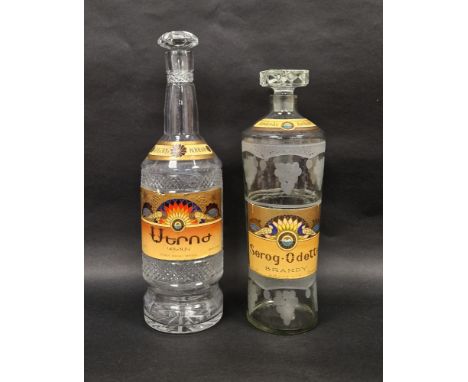 Two empty&nbsp;vintage glass Armenian brandy bottles with stoppers, the first Apapat Serog Odette, 20 years old, 40% proof, e