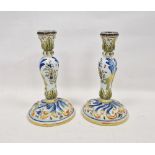 Pair of French faience baluster candlesticks, late 19th/early 20th century, painted with