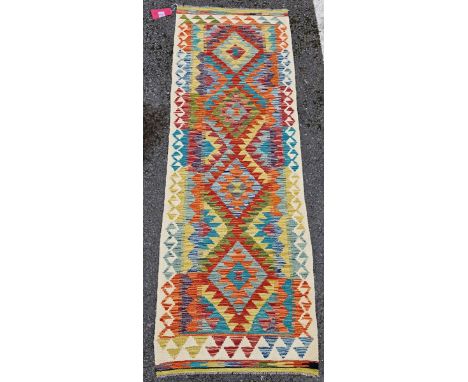 Chobi kilim runner, woven with bold geometric lozenges in orange, red, blue and yellow, within geometric pattern border, 197c