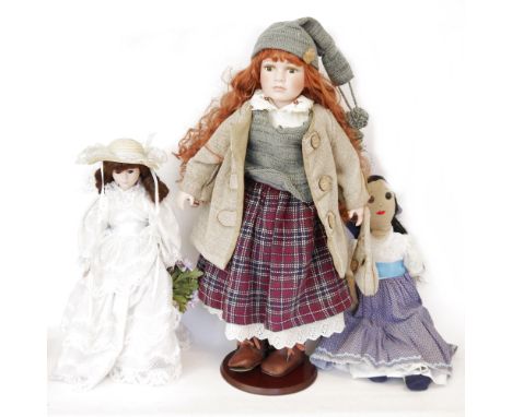 Sigikid limited edition tinted bisque headed doll&nbsp;with long auburn hair, no.558/1500, two similar dolls, boxed, a rag do