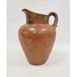 Large 20th century terracotta redware oviform water jug, incised with a band of fish amongst water