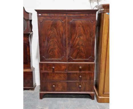 Victorian flamed mahogany linen press, the two door cupboard opening to reveal four trays, the base having two short over two