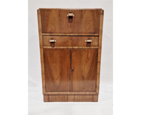 An Art Deco walnut veneer cocktail cabinet, the hinged top opening to reveal a mirrored storage area with fitted lemon squeez