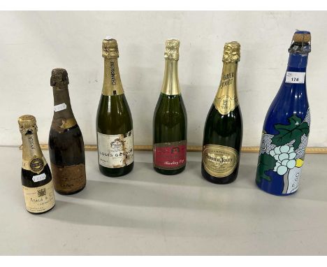 A group of six various bottles of champagne and sparkling wine