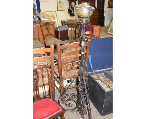 An iron framed brass oil lamp with later electrical conversion