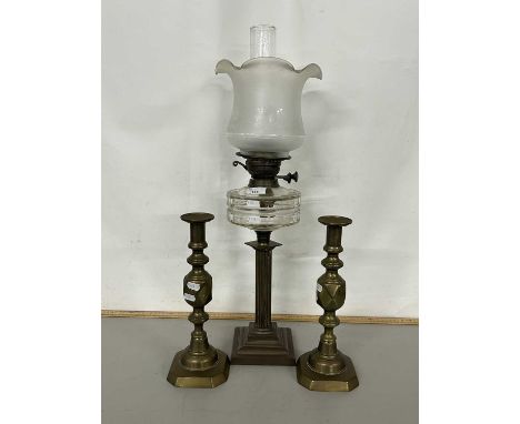 Brass based oil lamp and a pair of brass candlesticks