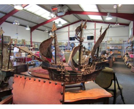 A pair of model reproduction ship galleons with rigging, sails, cannons and flags 