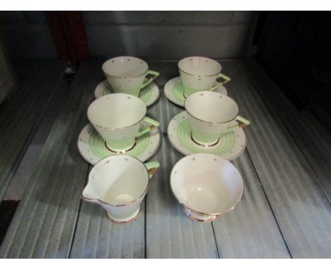 A Palissy Art Deco part coffee service comprising of four cups and saucers, cream jug and sugar bowl