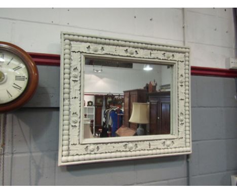 A painted wooden mirror with applied bobbin and acanthus leaf surround. 69cm x 79cm total