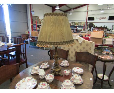 An ornate gilt classical design table lamp with pleated shade 