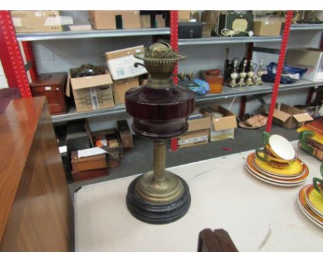 A cranberry pedestal oil lamp