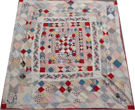 Mid-19th Century Block Patchwork Quilt, featuring a central square with pieced triangles, bordered by chintz alternating towa