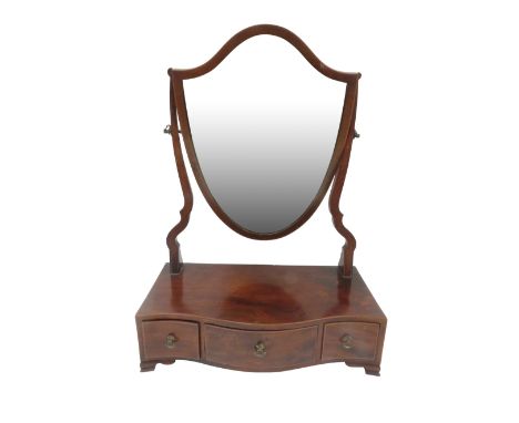 A 19th century mahogany shield shaped dressing table mirror with bow fronted drawers to base