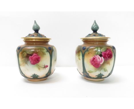 A pair of early 20th century Royal Worcester vases and covers, each with hand painted rose decoration and gilded, shape numbe