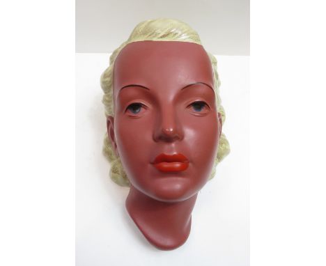 A Goldscheider mask, modelled as a female with blonde hair, with black backstamp 22cm high