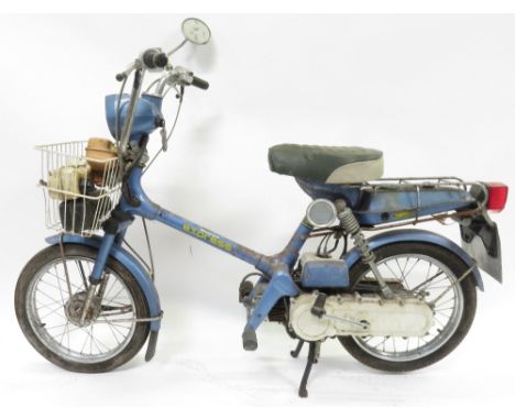 A Honda Express moped with light blue body and basket to front, reg DJM 643V, with key