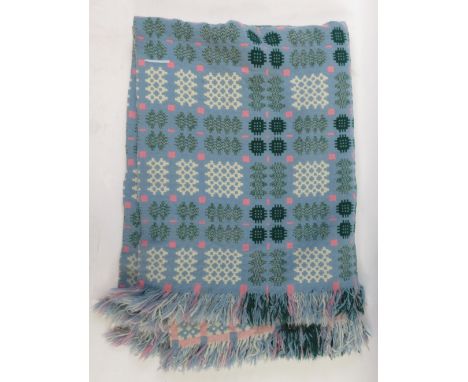 A Welsh blanket, light blue, with white, pinks and greens