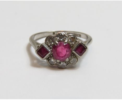 A ruby and diamond ring, the white mount stamped '18ct &amp; Plat' , the cushion shaped ruby measuring aprroximately 5.3mm by