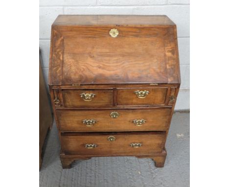 A 19th century oak bureau, with two long and three short drawers, with brass swing handles and bracket feet, 92cm high, 65cm 