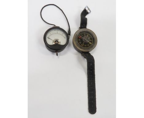 A German wrist compass, along with volt meter