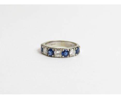 A diamond and sapphire 18 carat white gold half hoop ring, set with four sapphires and three brilliant cut diamonds, the diam