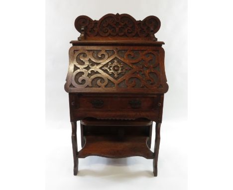 A 19th century oak bureau with carved front and back panel, with a bow front lower section, 133cm high, 74cm long, 39cm deep