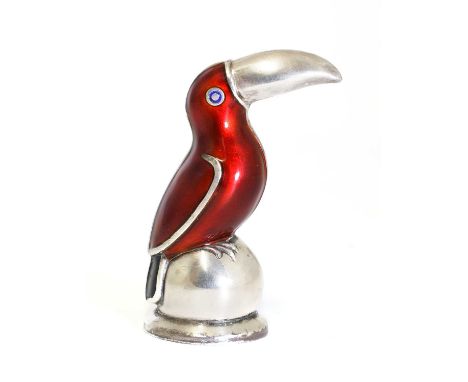 A sterling silver novelty toucan salt caster, by Meka, with red guilloché enamel and black tail feathers, perched on a ball, 