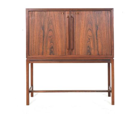 § A rosewood cocktail cabinet,  designed by Torbjørn Afdal for Mellemstrands Trevareindustri, Norway, the doors opening to re