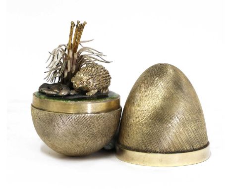 *A silver-gilt and enamel 'Surprise' egg,by Stuart Devlin, London 1978,with a textured surface and a polished central band, o