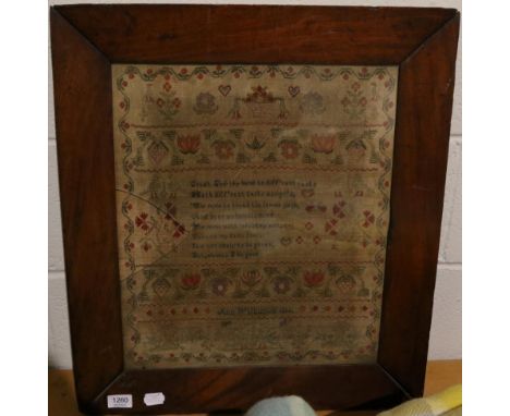 A 19th century needlework sampler by Ann Wilkinson 1834, with central religious verse surrounded by floral motifs and birds, 