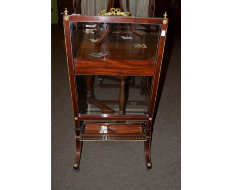 A 19th century mahogany and gilt metal mounted firescreen, in Louis XVI style, with urn shaped finials and ribbon tied handle