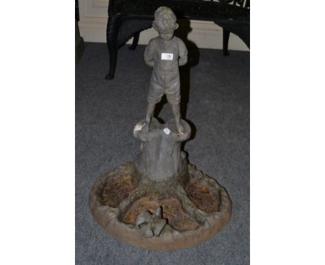 A lead figural bird bath, modelled as a boy stood on a tree trunk 