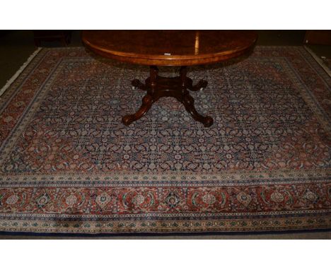 Indian carpet, modern, the indigo Herati field centred by a dove grey medallion framed by terracotta spandrels and samovar bo