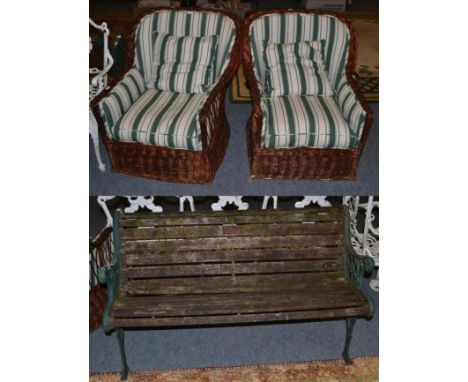 A Victorian green painted cast iron and wooden slatted garden bench; together with a pair of wicker conservatory chairs 