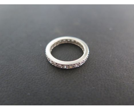 A white metal diamond eternity ring - size K - approximately 4.4 grams - some usage but generally good