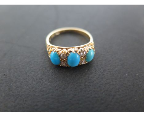 An 18ct yellow gold turquoise and diamond ring - size M - approximately 4.4 grams - centre stone approximately 6 x 4.5mm - so