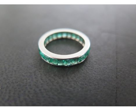 A white metal emerald eternity ring size L - approximately 3.4 grams - some minor wear - generally good.  A white metal diamo