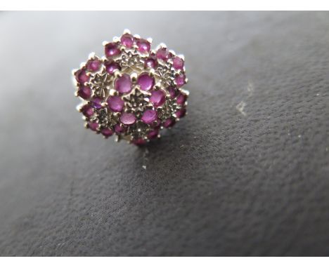 A 9ct yellow gold diamond and ruby cluster ring size K/L - approx weight 3.8 grams - surface scratches and usage wear