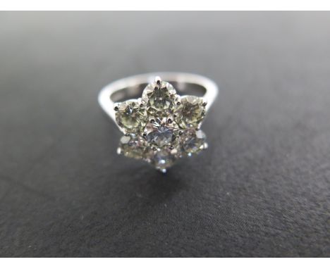 An 18ct white gold diamond seven stone cluster ring size Q - approx weight 6 grams - central diamond approx  0.50ct, flanked 