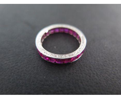 A platinum ruby eternity ring size K - approx weight 2.5 grams - some small wear to stones but generally good condition for a