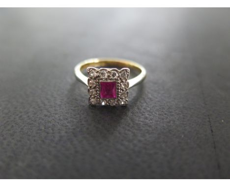 An 18ct yellow gold and platinum ruby and diamond ring - size K/L - approximately 2.5 grams - cluster 9 x 9 mm - overall good