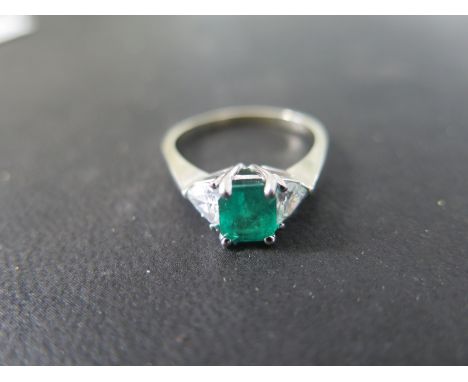 A 14ct white gold emerald and diamond ring - size R, approx 3.7 grams - emerald size approx 6.5mm x 5.5mm x 4.5mm depth - fla