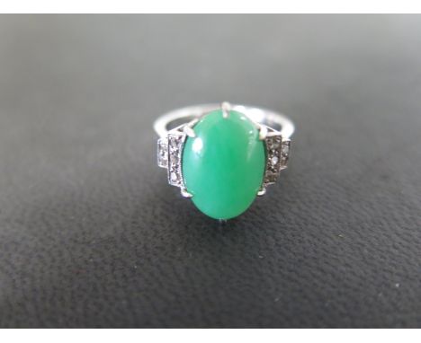 An early 20th Century 18ct and Platinum Jade and Diamond Dress Ring - 1 green jade oval stone, length 13.2mm, width 8.90mm, d