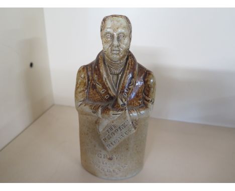 A salt glazed stoneware political flask in the form of a figure holding a scroll - 'The True Spirit of Reform' Grey's Reform 