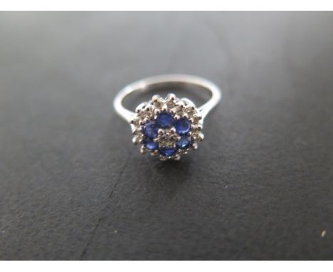 An 18ct white gold diamond and sapphire cluster ring - size M/N - approximately 3.5 grams - approximately 11mm diameter - ove